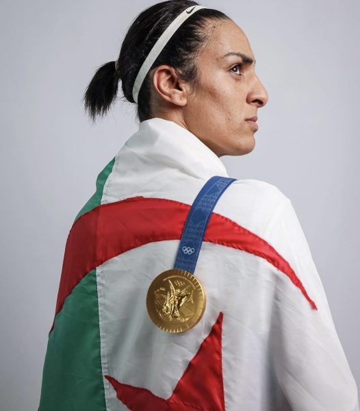 Algerian Boxer Imane Khelif dons her national flag and Olympic gold medal over her shoulder. 