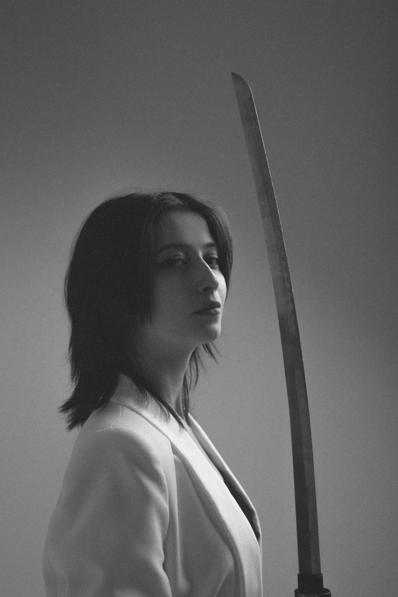Photo from Pexels: https://www.pexels.com/photo/monochrome-portrait-of-woman-with-katana-sword-31132020/